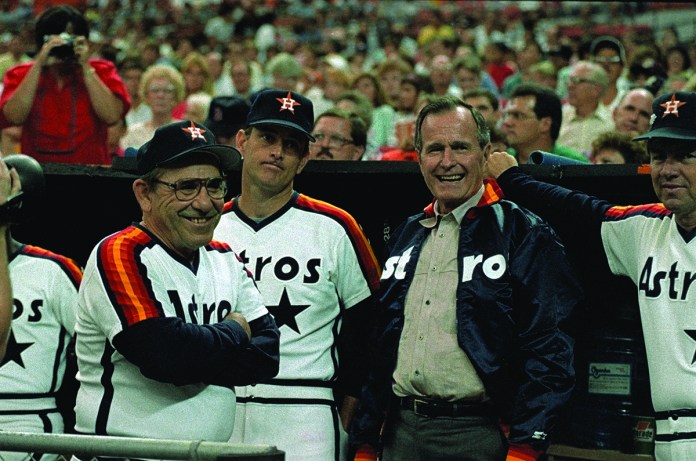 Vice President George Bush (right) chats with Houston Astros coach Yogi Berra (left) and pitcher Nolan Ryan in the dugout before the Astros-Pittsburgh Pirates game. Bush attended the game and threw out the opening pitch.