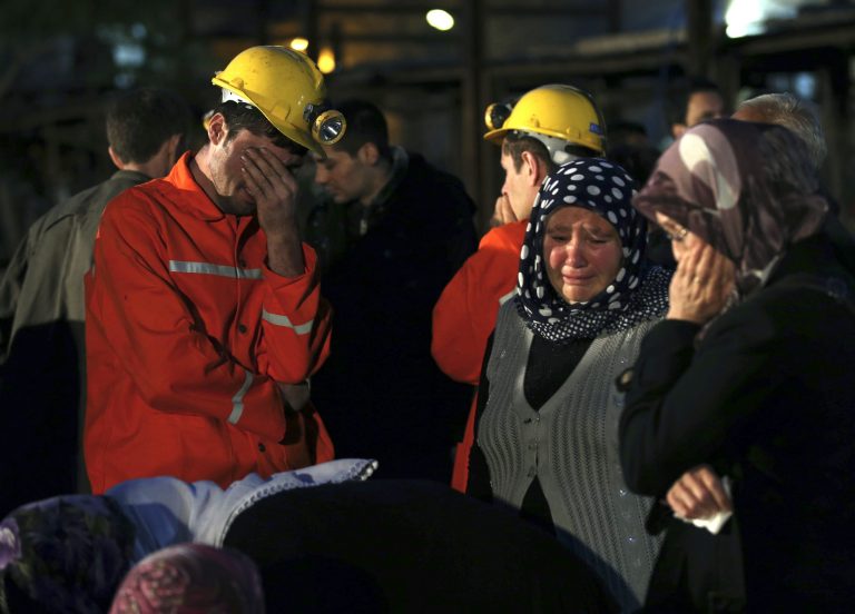 Miners and family members wait outside a coal mine following an explosion in Soma, western Turkey, early Wednesday, May 14, 2014. Rescuers desperately raced against time to reach more than 200 miners trapped underground Wednesday after an explosion and fire at the coal mine in western Turkey killed over 200 workers, authorities said, in one of the worst mining disasters in Turkish history. (AP Photo/Emrah Gurel)
