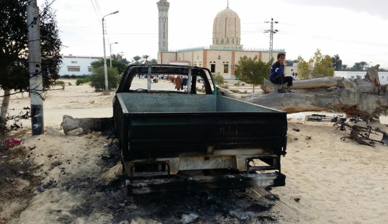 A burned truck is seen outside Al-Rawda Mosque in Bir al-Abd northern Sinai, Egypt a day after attackers killed hundreds of worshippers, on Saturday, Nov. 25, 2017. Friday's assault was Egypt's deadliest attack by Islamic extremists in the country's modern history, a grim milestone in a long-running fight against an insurgency led by a local affiliate of the Islamic State group. (AP Photo/Tarek Samy)