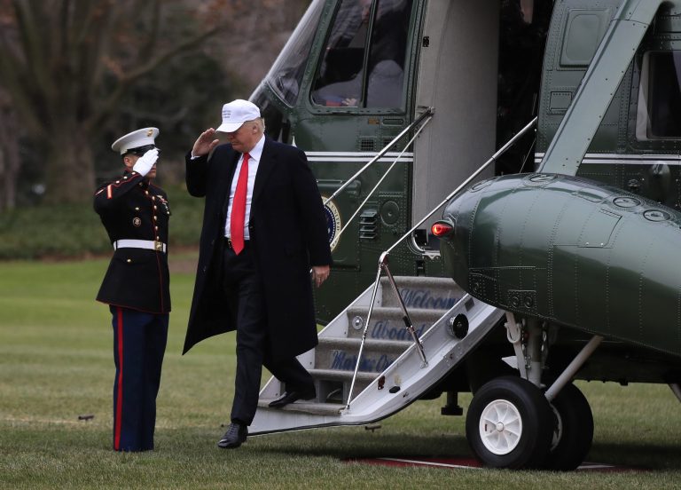 President Donald Trump salutes a Marines honor guard as he disembarks Marine One upon his return to the White House in Washington, Friday, Dec. 15, 2017, from a trip to Quantico, Va. (AP Photo/Manuel Balce Ceneta)