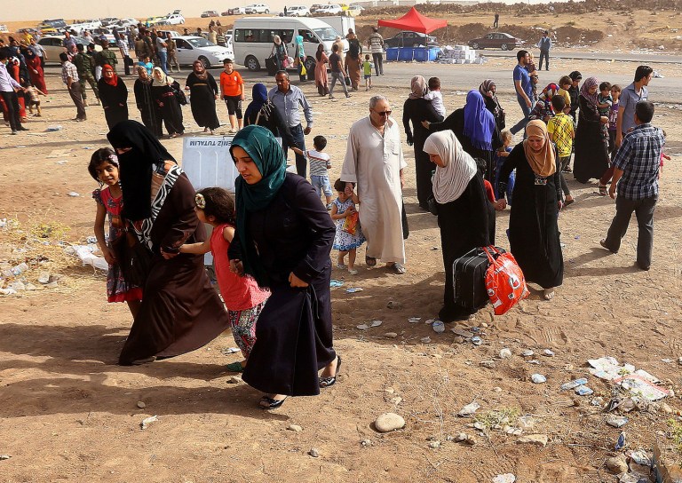 Refugees fleeing Mosul head to the self-ruled northern Kurdish region in Irbil, Iraq, 217 miles north of Baghdad, on Thursday. The Islamic State of Iraq and the Levant, the al Qaeda breakaway group, on Monday and Tuesday took over much of Mosul in Iraq and then swept into the city of Tikrit further south. An estimated half a million residents fled Mosul, an economically important city. (AP Photo)