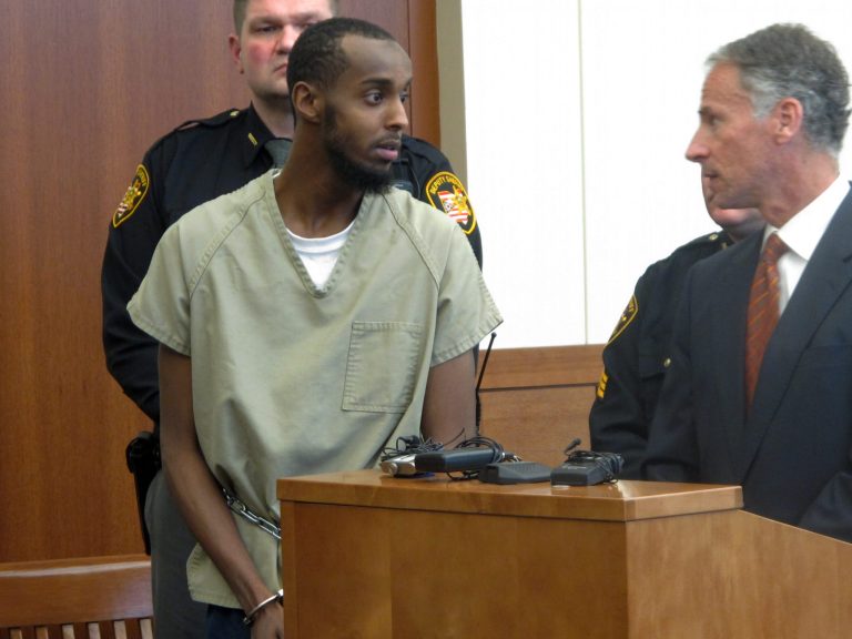 Abdirahman Sheik Mohamud, left, speaks with his defense attorney, Sam Shamansky, during a hearing to set bond on charges of money laundering and providing support for terrorism, on Wednesday, Feb. 25, 2015, in Columbus, Ohio. (AP Photo/Andrew Welsh-Huggins)