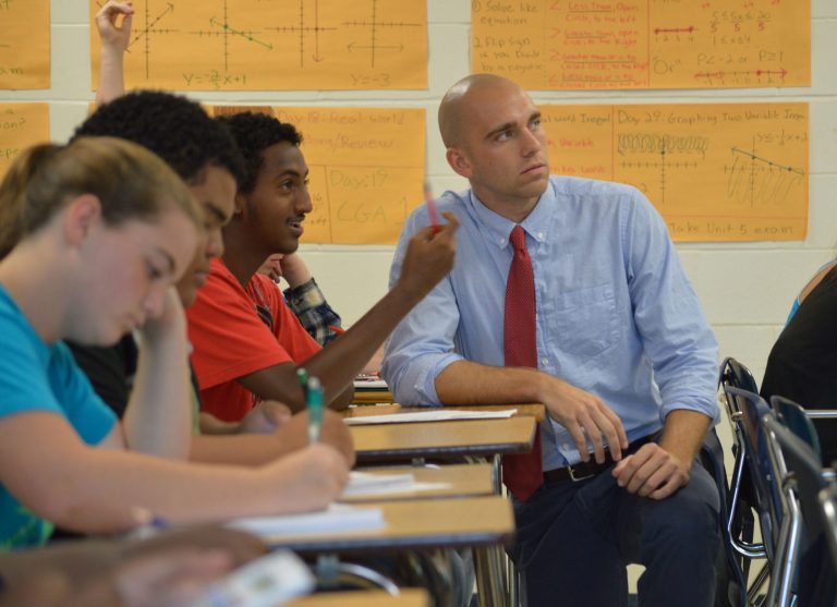In this May 27, 2014 photo provided by the Jacksonville Public Education Fund, Brian Ellis, an algebra teacher, works with his students at First Coast High School. Ellis is a Jacksonville School Leadership Fellow, a Quality Education for All program that takes high-performing teachers and trains them to become school principals. A Monday, Oct. 6, 2014 report by the Chronicle of Philanthropy detailed how Jacksonville donors had rallied behind a campaign to improve the region's public schools via a Quality Education for All fund launched in 2005 with a goal of raising $50 million. (AP Photo/Jacksonville Public Education Fund, Susan Sanders)