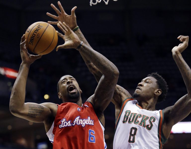   Los Angeles Clippers' DeAndre Jordan (6) is fouled by Milwaukee Bucks' Larry Sanders (8) as he goes up for a shot during the first half of an NBA basketball game Saturday, Dec. 15, 2012, in Milwaukee. (AP Photo/Morry Gash)  