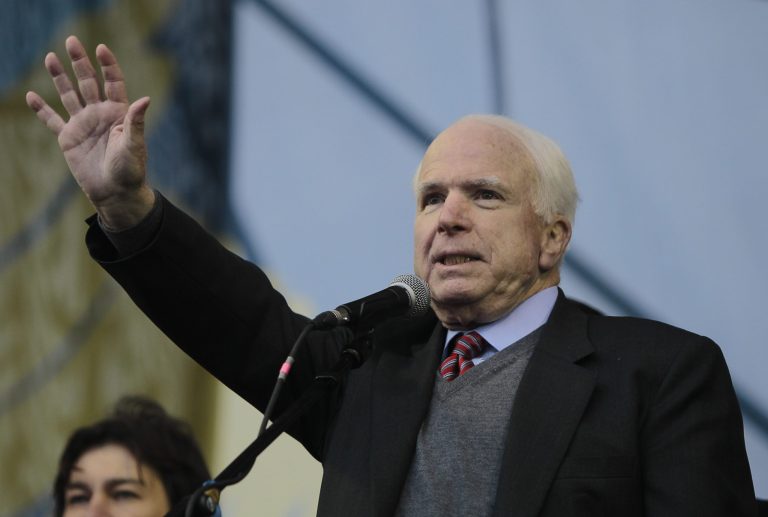 U.S. Senator John McCain gestures while speaking to Pro-European Union activists gathered during a rally in Independence Square in Kiev, Ukraine, Sunday, Dec. 15, 2013. (AP Photo/Sergei Chuzavkov)