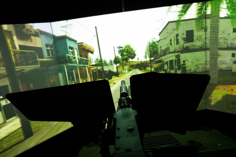 An engineer demonstrates a Combat Convoy Simulator at Lockheed Martin's innovation center in Orlando, Fla. The company won a contract on Monday for development work on unmanned military transports. 