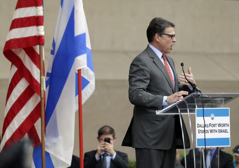 Texas Gov. Rick Perry speaks during a rally supporting Israel in front of city hall in Dallas, Texas, Wednesday, July 30, 2014. Gov. Perry criticized on Wednesday an American 