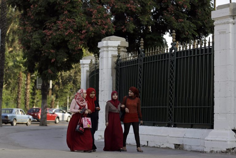 In this Thursday, Oct. 7, 2014 photo, Egyptian students walk outside Cairo University in Cairo, Egypt. Summer vacation ends this weekend, and universities across Egypt are preparing for the return of students with a heavy, pre-emptive clampdown. The aim is to prevent a resurgence of protests by supporters of Mohammed Morsi, the Islamist president who was removed by the military just over a year ago. (AP Photo/Hassan Ammar)