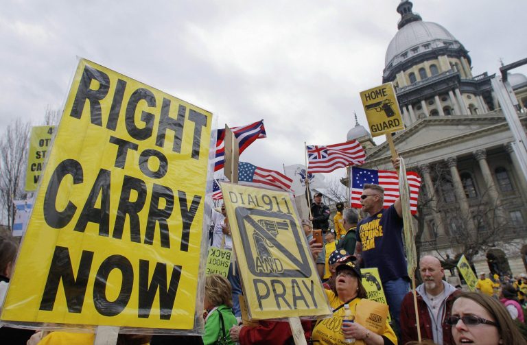 FILE - In this March 7, 2012 file photo, gun owners and supporters participate in an Illinois Gun Owners Lobby Day rally at the Illinois State Capitol in Springfield. In a big victory for gun rights advocates, a federal appeals court on Tuesday, Dec. 11, 2012, struck down a ban on carrying concealed weapons in Illinois _ the only remaining state where carrying concealed weapons is entirely illegal. (AP Photo/Seth Perlman, File)