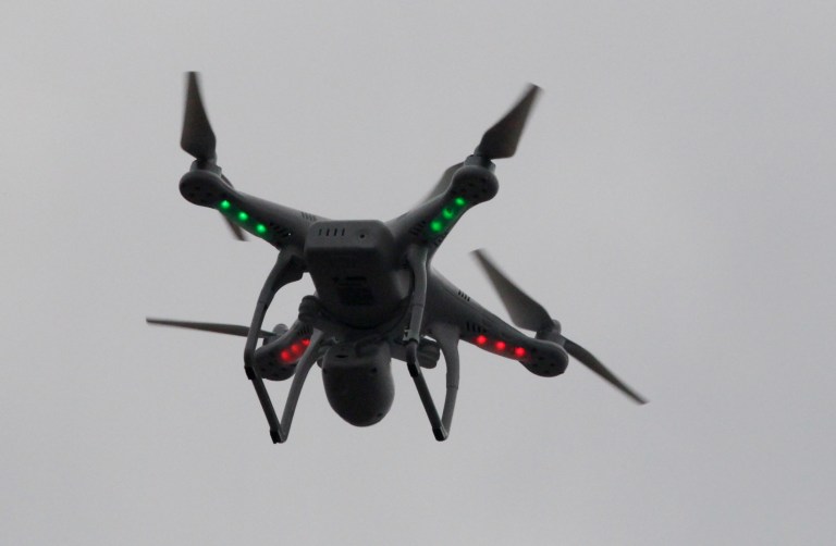 FILE - This March 12, 2014 file photo shows a drone landing after flying over the scene of an explosion that leveled two apartment buildings in East Harlem in New York. Brian Wilson, the owner, says he uses the aerial drone to document buildings, weddings and news events. The Federal Aviation Administration bars commercial use of drones no matter how seemingly benign. Officials say rules to address the special safety challenges associated with unmanned aircraft need to be in place before they can share the sky with manned aircraft and final regulations could be years away. But tempting technology and an eager marketplace are outrunning the aviation agency's best intentions. Photographers, real estate agents, moviemakers, and others are hurrying to embrace the technology. (AP Photo/Mark Lennihan, File)