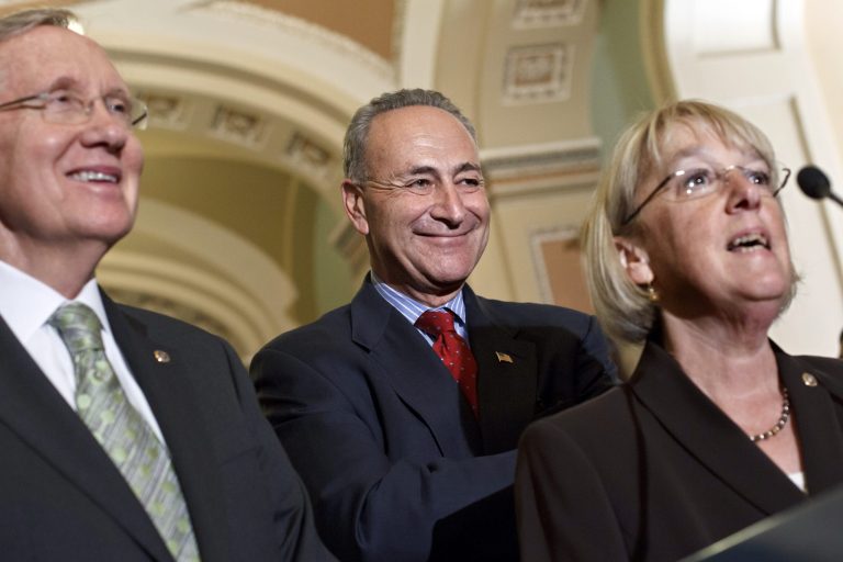 From left, Senate Majority Leader Harry Reid, D-Nev., Sen. Charles Schumer, D-N.Y., and Sen. Patty Murray, D-Wash., talk to reporters just after Senate Democrats passed their version of a yearlong tax cut extension bill by a near party-line 51-48 vote, at the Capitol in Washington, Wednesday, July 25, 2012.  (AP Photo/J. Scott Applewhite)