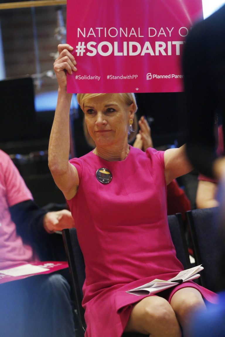 Cecile Richards, national head of Planned Parenthood, holds aloft a placard during a rally in Englewood, Colo., on Saturday, Dec. 5, 2015. The event was organized as a response to the mass shooting at a Planned Parenthood clinic in Colorado Springs, Colo., a week ago in which three people died. (AP Photo/David Zalubowski)