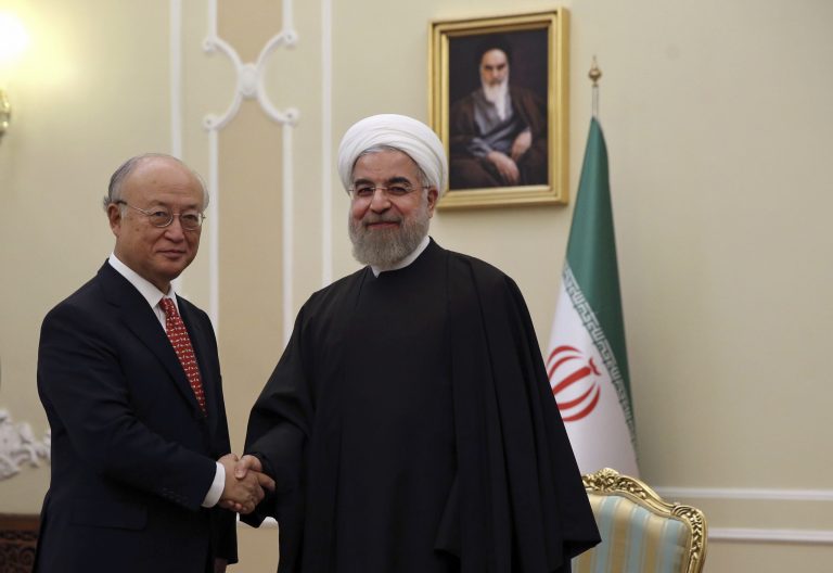 Iranian President Hassan Rouhani, center, welcomes U.N. nuclear chief Yukiya Amano at the start of their meeting in Tehran, Iran, Sunday, Sept. 20, 2015. Iran's state TV is reporting Amano has arrived in Tehran to 