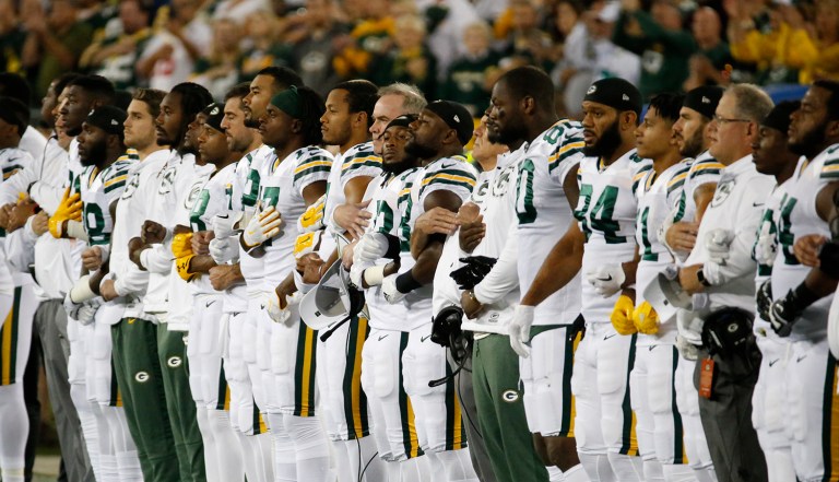 During last weekend's games, some players and teams didn't even come out of the locker room during the national anthem, while others knelt or linked arms for the song. (AP Photo/Mike Roemer)
