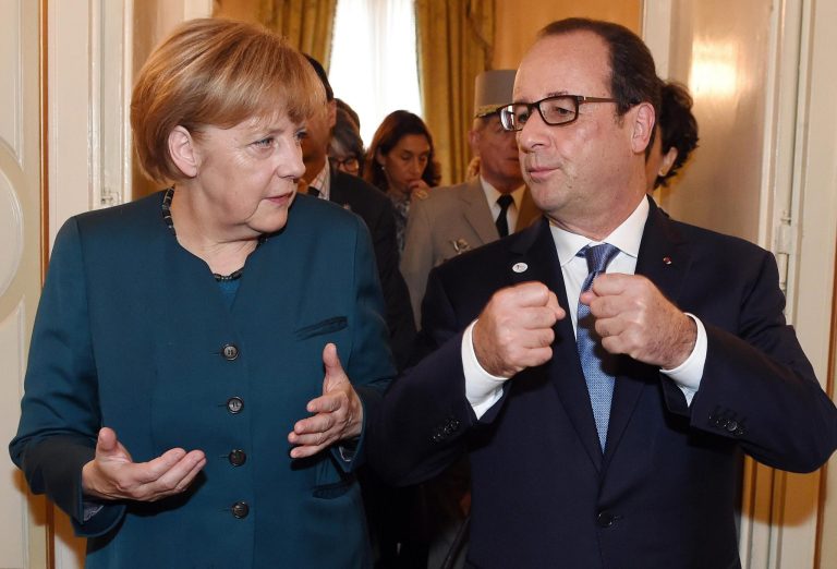 German Chancellor Angela Merkel, left, and French President Francois Hollande talk after a meeting on the sidelines of the  ASEM summit of European and Asian leaders in Milan, northern Italy, Friday, Oct. 17, 2014. Russian President Vladimir Putin is looking to get relief from Western economic sanctions imposed since Russia's annexation of the Crimean Peninsula and its support for a pro-Russia insurgency in eastern Ukraine. To that end, he has scheduled a series of meetings on the sidelines of a two-day ASEM summit of European and Asian leaders. (AP Photo/Daniel Dal Zennaro, POOL)