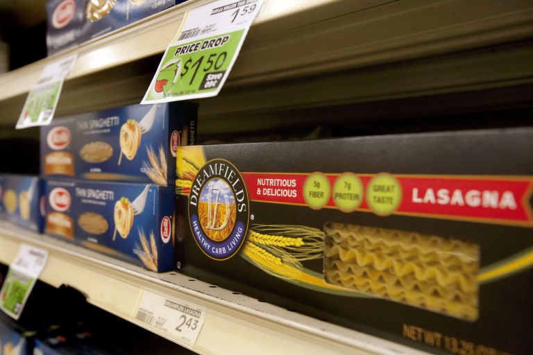 In this May 9, 2014 photo, Dreamfields Pasta is seen on the shelves of a  grocery store in Farno, N.D. A company accused of falsely advertising the health benefits of its nationally distributed Dreamfields Pasta has agreed to pay $5 million to consumers as part of a class-action settlement. The complaint accuses Carrington, North Dakota-based Dakota Growers Pasta and its parent company of bogus claims that the product was a low-carbohydrate alternative to traditional pasta. (AP Photo/Bruce Crummy)