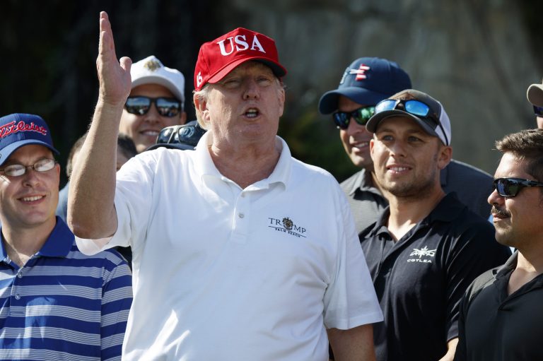 President Donald Trump speaks as he meets with members of the U.S. Coast Guard, who he invited to play golf, at Trump International Golf Club, Friday, Dec. 29, 2017, in West Palm Beach, Fla. (AP Photo/Evan Vucci)