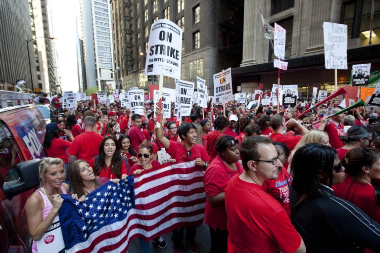 FILE - This Sept. 10, 2012, file photo shows thousands of public school teachers rallying outside the Chicago Public Schools district headquarters on the first day of strike action over teachers' contracts in Chicago. A majority of union members today now have ties to a government entity at the federal, state or local levels. The typical union worker now is more likely to be an educator, office worker or food or service industry employee rather than a construction worker, autoworker, electrician or mechanic, with far more women than men among the ranks. Overall, 11.3 percent of U.S. wage and salary workers are unionized, down from a peak of 35 percent during the mid-1950s.  (AP Photo/Sitthixay Ditthavong, File)