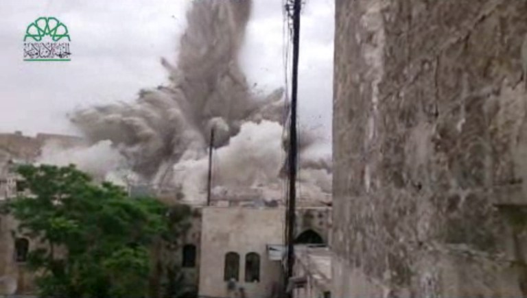 This image made from amateur video posted by Shaam News Network (SNN), an anti-Bashar Assad activist group, which has been verified and is consistent with other AP reporting, shows an explosion that destroyed the Carlton Hotel in Aleppo, Syria, Thursday, May 8, 2014. The rebel-claimed bombing Thursday in the northern Syrian city leveled the once luxurious hotel near the ancient Citadel that government troops used as a military base, causing multiple casualties, activists and militants said.(AP Photo/Shaam News Network via AP video)