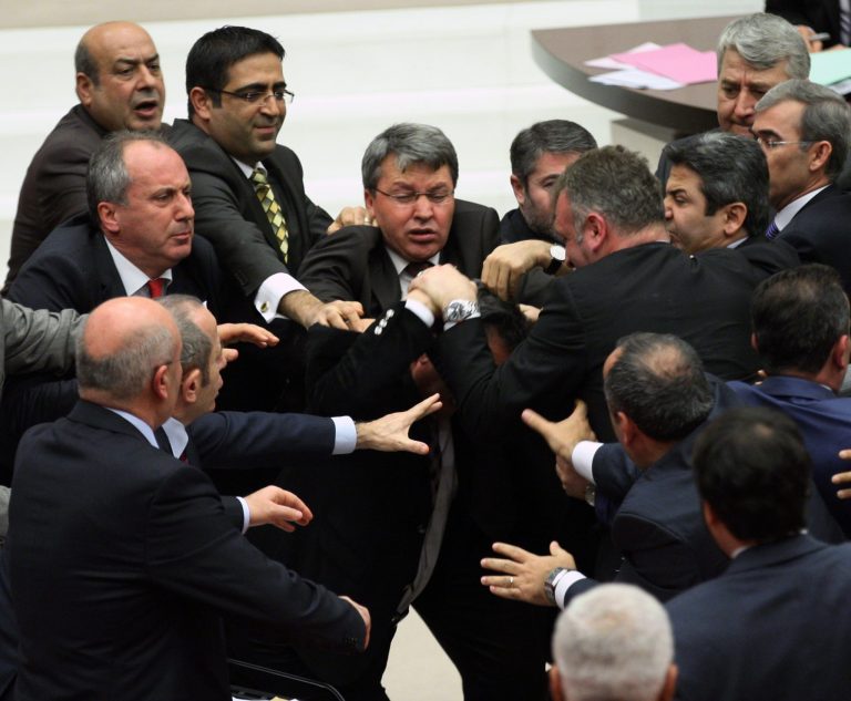 Ruling party lawmakers, right, and the members of the main opposition brawl  in Turkey's parliament during a debate over a corruption scandal that has ensnared Prime Minister Recep Tayyip Erdogan's government, in Ankara, Turkey, Thursday, Jan. 23, 2014. One opposition party legislator was hospitalized after being punched in the face. The scuffles erupted Thursday as parliament prepared to resume debate on a much-criticized draft bill that would tighten the government's control over the judiciary as it fights a corruption probe that has become one of the most serious threats to its decade in power.(AP Photo)