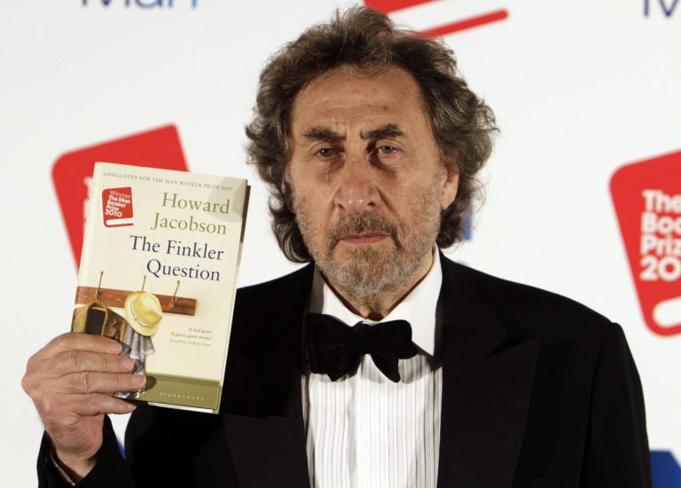 FILE - In this Tuesday Oct. 12, 2010 file photo, British author Howard Jacobson, displays his book 'The Finkler Question', winner of  the Man Booker Prize for Fiction 2010, following the announcement at central London. Three British writers, two Americans and an Australian are finalists for the prestigious Booker Prize for fiction. The British nominees, announced Tuesday, are Ali Smith's 