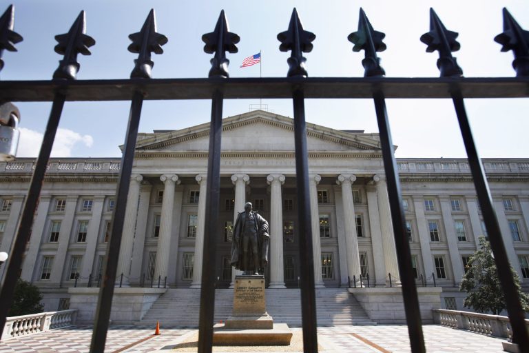 FILE - In this Monday, Aug. 8, 2011, file photo, a statue of former Treasury Secretary Albert Gallatin stands outside the Treasury Building in Washington. The Treasury Department reports on the federal budget picture for April and for the fiscal year thus far on Monday, May 12, 2014. 