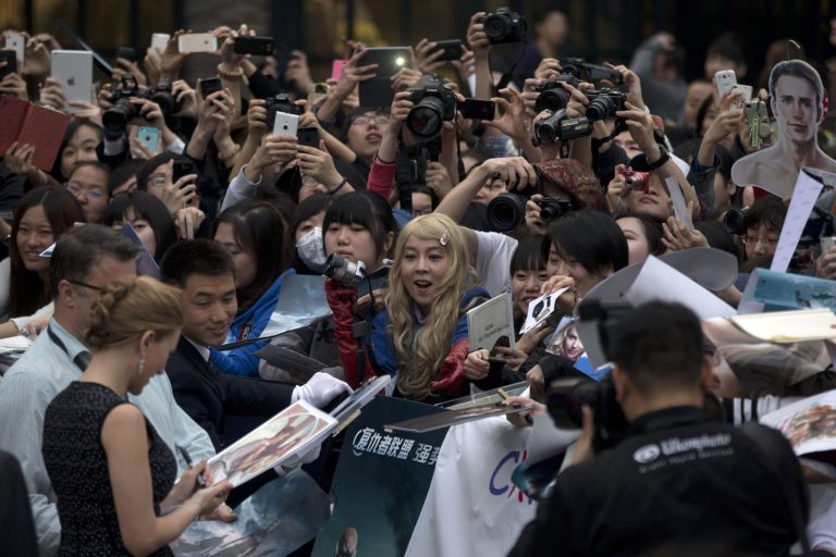 HOLD FOR STORY CHINA HOLLYWOOD MOVIES BY LOUISE WATT In this photo taken Monday, March 24, 2014, actress Scarlett Johansson signs autograph for fans during a publicity event ahead of the April release of the movie 