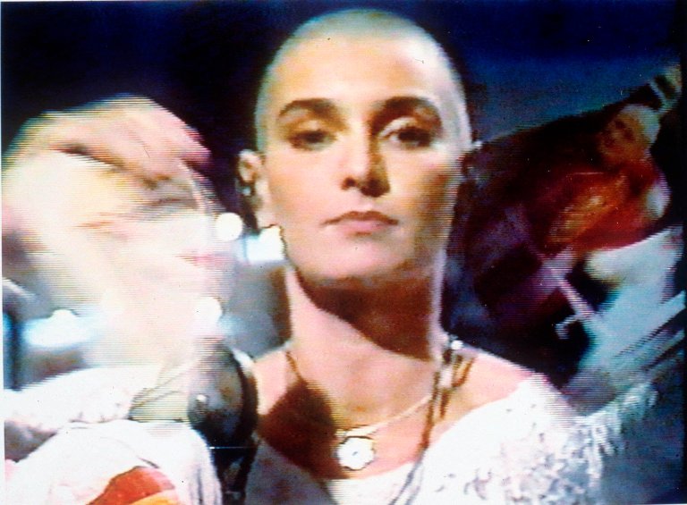 Singer Sinead O'Connor tears up a photo of Pope John Paul II during a live appearance in New York on NBC's 