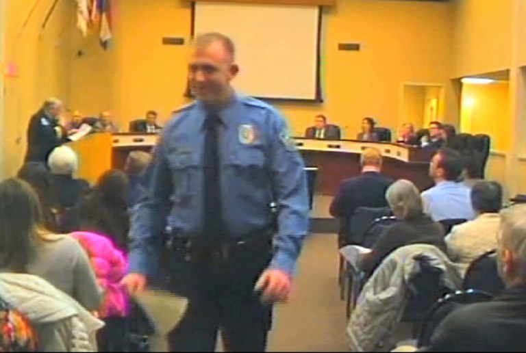 In this Feb. 11, 2014 file image from video released by the City of Ferguson, Mo., officer Darren Wilson attends a city council meeting in Ferguson. (AP Photo/City of Ferguson, File)