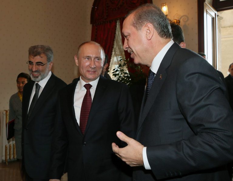  Russian President Vladimir Putin, center, and Turkey's Prime Minister Recep Tayyip Erdogan, right, speake before a meeting in Istanbul, Turkey, Monday, Dec. 3, 2012. Putin visits Turkey on a one-day trip expected to focus on economic issues as well as differing views over how to resolve the Syrian conflict. Turkish Energy Minister Taner Yildiz is at left.(AP Photo/Pool)  
