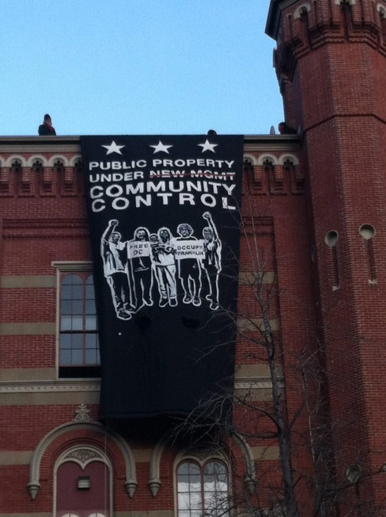 Masked protesters broke into the abandoned Franklin School at 13th and K Streets, near the Occupy DC Camp.