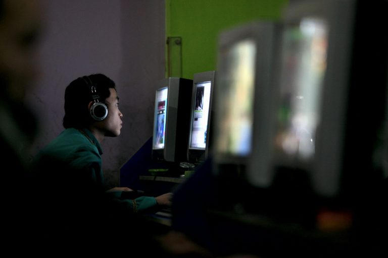 A Chinese youth plays online game in a net cafe on January 21, 2008 in Chongqing Municipality, China. (Photo by China Photos/Getty Images)