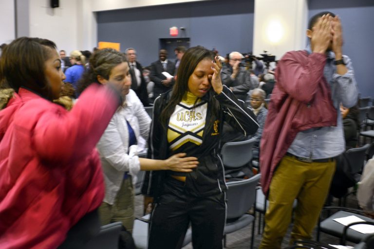 Students and staff from University City High School react after their school was closed by the School Reform Commission in Philadelphia, Thursday, March 7, 2013. School officials say many of the buildings have too many empty seats and are in poor condition. They say consolidating will save the cash-strapped district about $24 million per year. (AP Photo/The Philadelphia Inquirer, Tom Gralish)