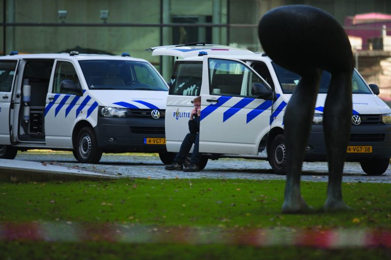 A forensic expert talks on his mobile phone as police vehicles are parked near a statue at the back entrance of Kunsthal museum in Rotterdam, Tuesday Oct. 16, 2012. Several paintings have been stolen from a museum in the Dutch city of Rotterdam that was exhibiting works by Pablo Picasso, Henri Matisse and Vincent van Gogh. At least several paintings were stolen early Tuesday morning from the Kunsthal museum , but their names have not yet been released. They are believed to include at least one by Henri Matisse, the 1919 