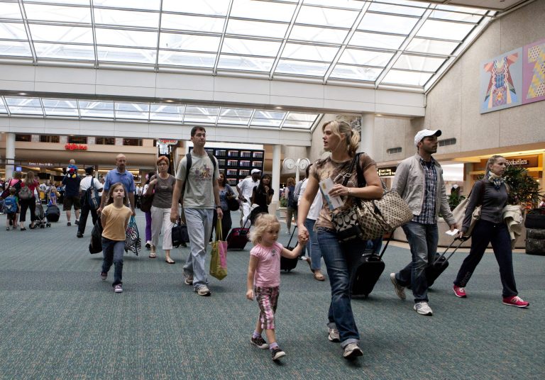  FILE - In this Friday, May 25, 2012 file photo, travelers arrive at Orlando International Airport make their way to baggage claim in Orlando, Fla. Flying this summer doesnât need to be expensive, as search engines, social media, creativity and flexibility can make finding bargain airfares easier. (AP Photo/John Raoux, File)  