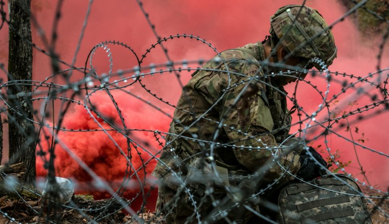A combat medic assigned to the 82nd Airborne Division, Fort Bragg, N.C., readies his equipment before embarking on his final evaluation lane while competing for the Expert Field Medical Badge Nov. 6, 2018, at Fort Bragg, N.C. The first week of testing introduces the candidates to all the tasks that theyâll be expected to complete to earn the coveted badge. The EFMB was established to showcase and recognize medical Soldiers for their exceptional skill level and competence in the medical field. The testing consists of a written exam, land navigation, three separate combat testing lanes and concludes with a 12-mile ruck march. 
