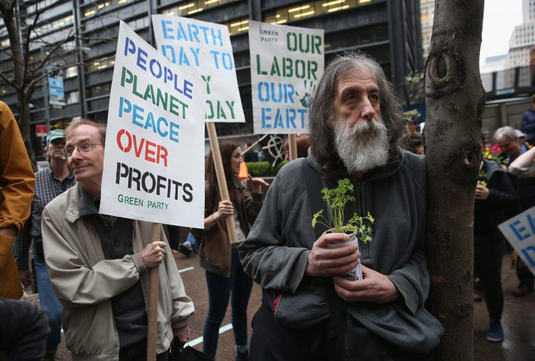 Environmental activists attend a protest in Zucotti Park on Earth Day on April 22, 2014 in New York City. About three dozen activists marched around New York's financial district calling for greater respect for the environment. (Photo by John Moore/Getty Images)