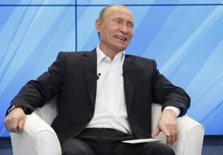 Prime Minister Vladimir Putin laughs as he and Russia's President Dmitry Medvedev, unseen, meet with their supporters in Moscow,  Russia, Thursday, Dec. 1, 2011. (AP Photo/Alexander Zemlianichenko, pool)