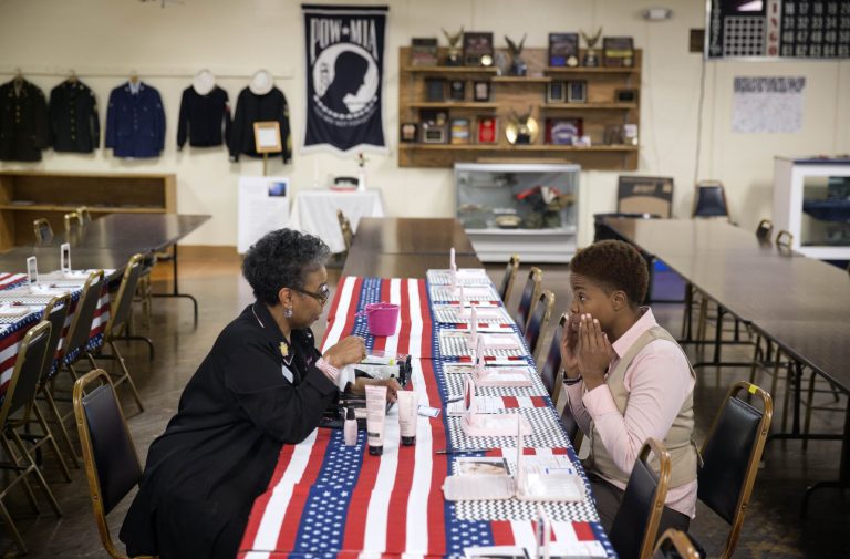 FILE - In this Thursday, Nov. 14, 2013, file photo, U.S Air Force Staff Sgt. Bri Smith, 31, right, of Atlanta, samples a facial moisturizer product while talking with Mary Kay consultant Asenath Holmes Pitner, left, during a job fair for veterans at the VFW Post 2681, in Marietta, Ga. Payroll processor ADP issues its report Wednesday, Dec. 4, 2013, on job growth among private companies in November. (AP Photo/David Goldman, File)
