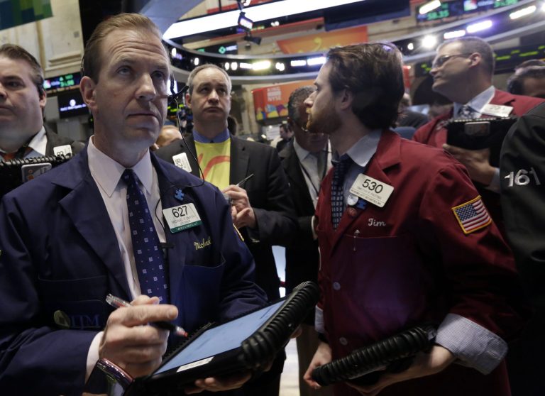 Michael Smyth, left, works with fellow traders on the floor of the New York Stock Exchange, Wednesday, March 26, 2014.  The stock market opened higher Wednesday after a strong report on American manufacturing. The maker of the hit game 