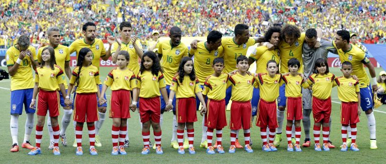 The Brazil team react after singing their national anthem before the group A World Cup soccer match between Brazil and Mexico at the Arena Castelao in Fortaleza, Brazil, Tuesday, June 17, 2014.  (AP Photo/Andre Penner)