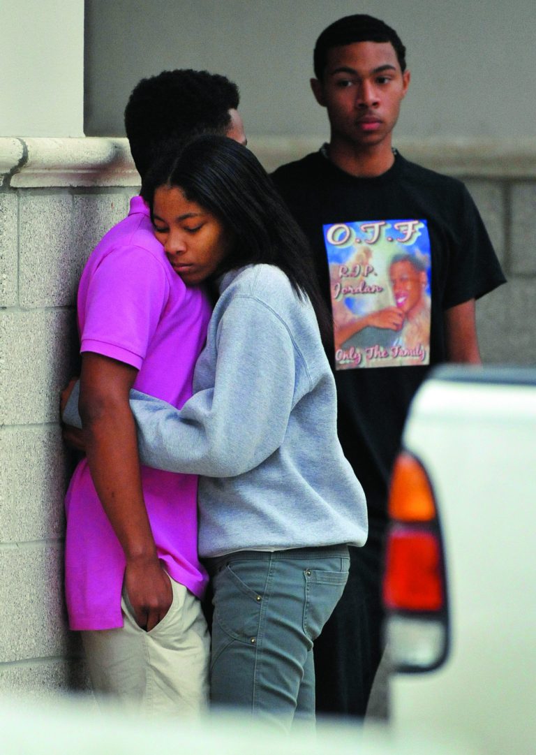 Friends of Jordan Davis comfort each other outside the funeral home where the visitation with Davis' family was taking place in Jacksonville, Fla. (AP Photo/The Florida Times-Union, Bob Self)