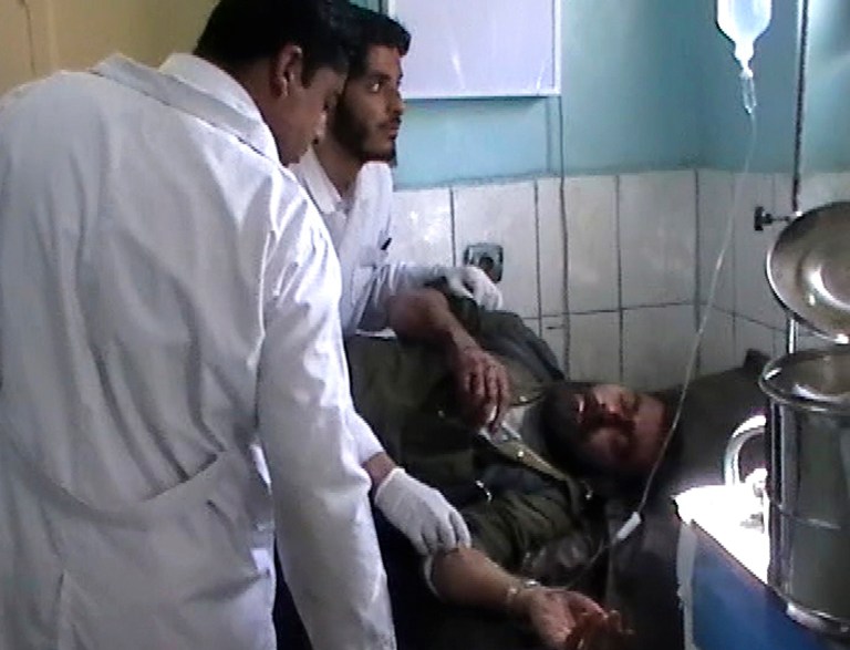 This image made from AP video shows doctors attending to an injured man at the local hospital in Farah, western Afghanistan, Wednesday, April 3, 2013. Suicide bombers disguised as Afghan soldiers stormed a courthouse Wednesday in a failed bid to free more than a dozen Taliban prisoners in western Afghanistan, officials said. Scores of people, including the attackers, were reported killed in the fighting. The assault in Farah province was the latest example of the Taliban's ability to strike official institutions despite tight security measures. (AP Photo/APTN)