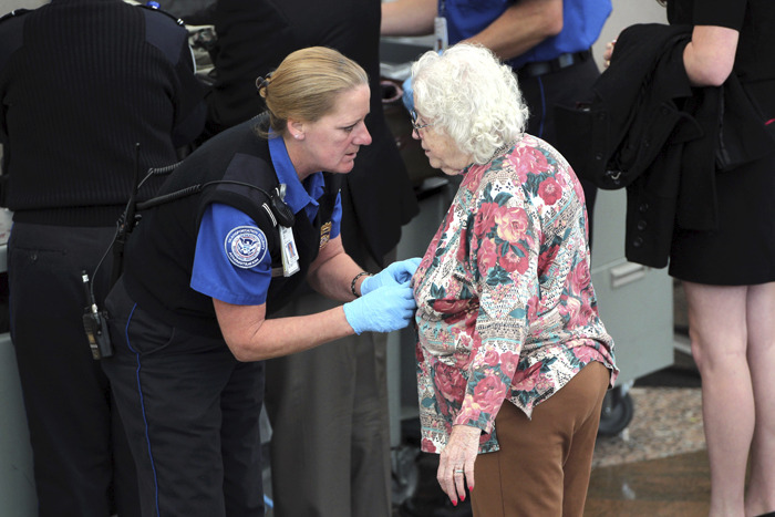 A traveler undergoes an enhanced pat down by a Transportation Security Administration agent at the Denver International Airport in Denver, Colorado. (John Moore/Getty Images)