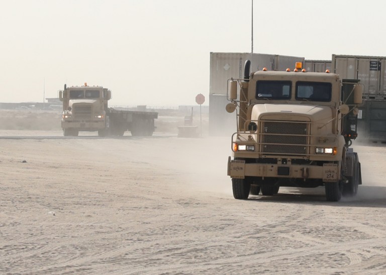 Tractor-trailer trucks driven by National Guardsmen, deployed to Kuwait with the Las Vegas, New Mexico, based 720th Transportation Brigade, arrived May 6, 2021, at the Ammunition Supply Point at Camp Arifjan, Kuwait, with palletized bundles of munitions retrograded from Afghanistan.