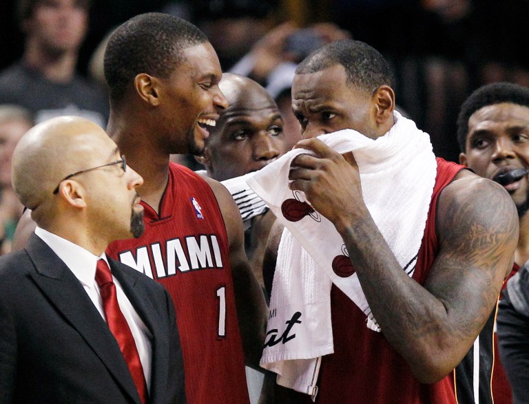   Miami Heat's Chris Bosh (1) laughs as LeBron James, right, speaks while they wait for the end of Game 6 against the Boston Celtics in the NBA basketball Eastern Conference finals, Thursday, June 7, 2012, in Boston. At left is Heat assistantÂ coach David Fizdale. Miami won 98-79. (AP Photo/Elise Amendola)  