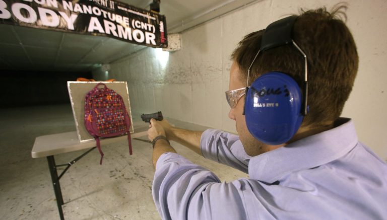   Rick Brand, Chief Operating Officer of Amendment II, shoots a 9 mm pistol into a children's backpack, left, fitted with an anti-ballistic insert, during a demonstration at a gun range, Wednesday, Dec. 19, 2012, in Taylorsville, Utah. Anxious parents reeling in the wake the Connecticut school shooting are fueling sales of armored backpacks for children, as firearms enthusiasts stock up on assault rifles nationwide amid fears of imminent gun control measures. At Amendment II, sales of children backpacks and armored inserts are up 300 percent. (AP Photo/Rick Bowmer)  