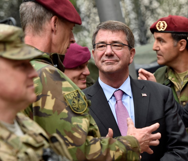 Secretary of Defense Ashton Carter, right, listens to NATO Response Force soldiers during his visit to the I. German-Dutch Brigade in Muenster, Germany, Monday, June 22, 2015. The troops are part of NATO's Very High Readiness Joint Task Force. (AP Photo/Martin Meissner)