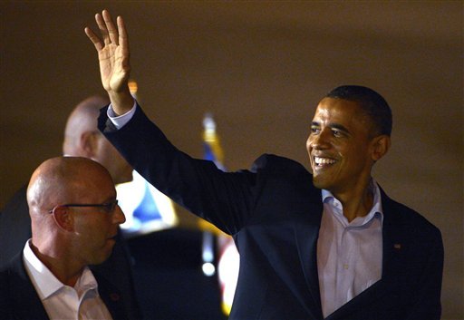 President Barack Obama waves to supporters on the tarmac before getting into his limousine after arriving at Orlando International Airport in Orlando, Fla., Sunday, Oct. 28, 2012.(AP Photo/Phelan M. Ebenhack)