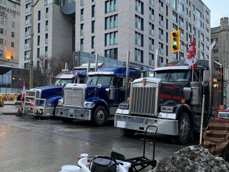 Three massive trucks clog up a busy street in Ottawa, Canada as part of a protest over COVID-19 vaccine mandates. 